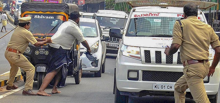Kannur: Police detain DYFI activists who were trying to block Karnataka Chief minister BS Yediyurappa’s vehicle during a protest in Kannur, Tuesday, Dec. 24, 2019. (PTI Photo)