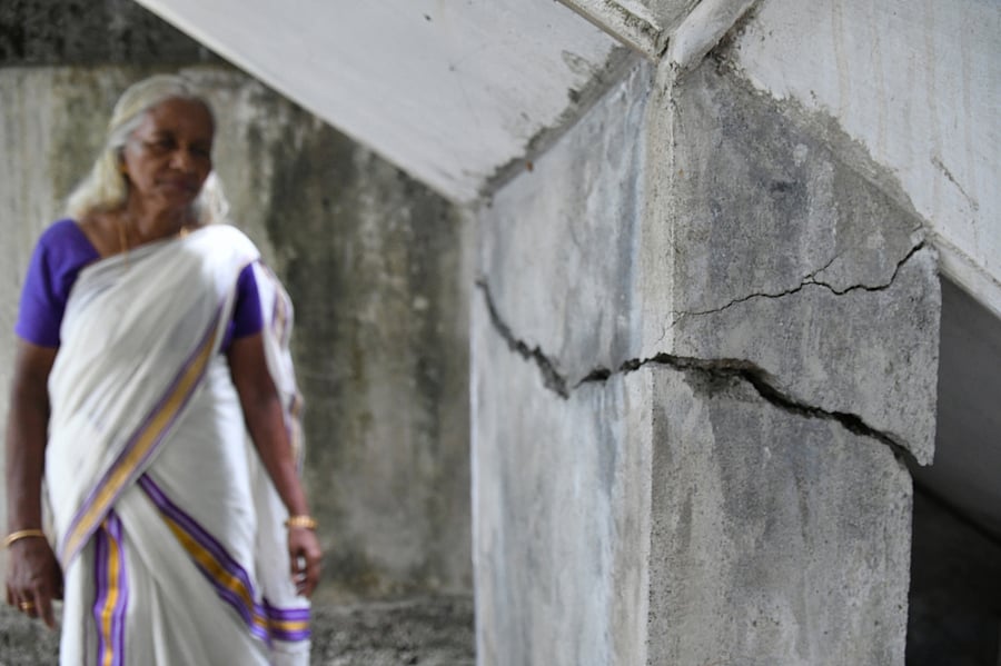 Harshamma, residing near Alfa Serene apartment, showing the cracks developed at her house following the preliminary demolition activities at the apartment.