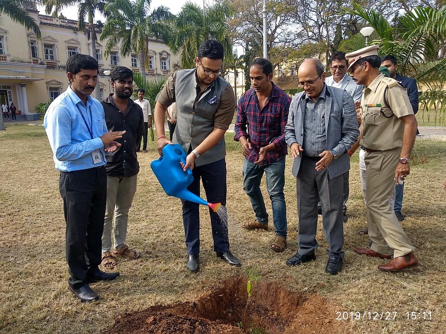 Royal scion Yaduveer Krishnadatta Chamaraja Wadiyar plants a sandalwood sapling to mark his visit to CSIR-Central Food Technological Research Institute (CFTRI), in Mysuru, on Friday. CFTRI Director K S M S Raghava Rao and India-head of Silicon Road S Sanj