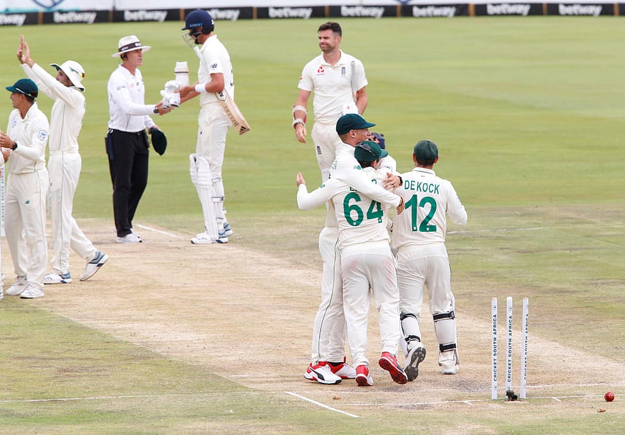 South Africa' Quinton de Kock celebrates winning the test match with teammates as England's James Anderson looks dejected. Reuters