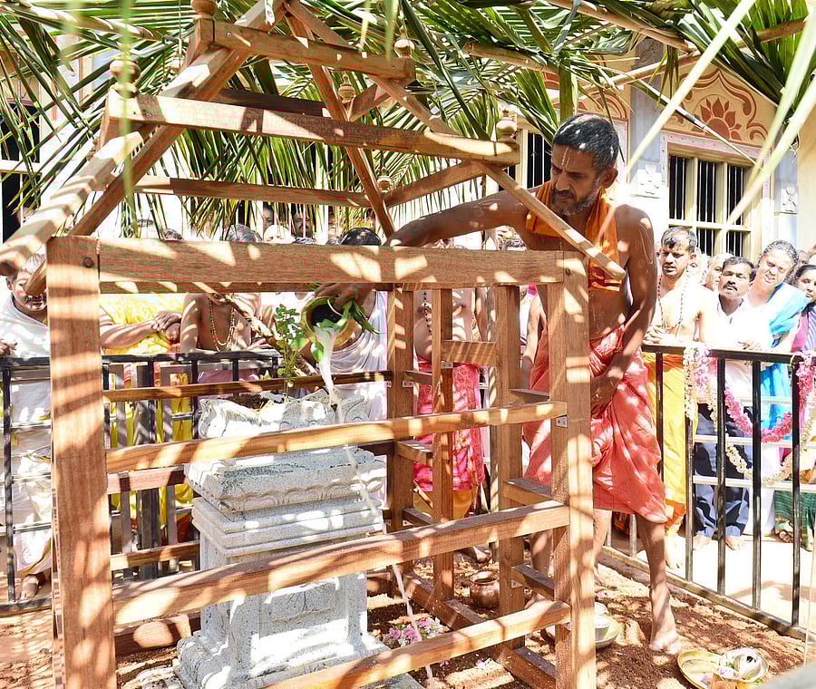 Pejawar seer Vishwaprasanna Theertha Swami performs abhisheka to the Brindavana of his predecessor Vishwesha Theertha Swami in Bengaluru on Monday. dh photo
