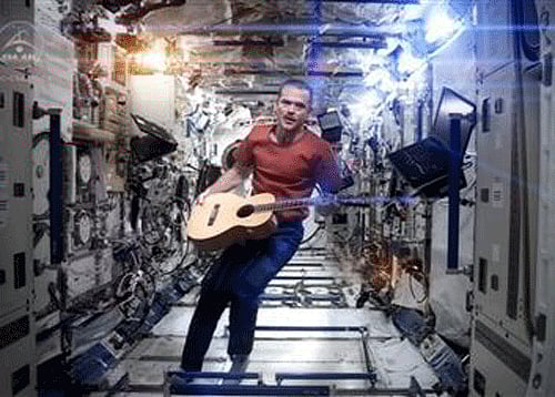 Canadian astronaut and International Space Station (ISS) Commander Chris Hadfield performs his zero-gravity version of David Bowie's hit ''Space Oddity'' in this image taken from video, courtesy of Chris Hadfield, NASA and CSA.  Reuters