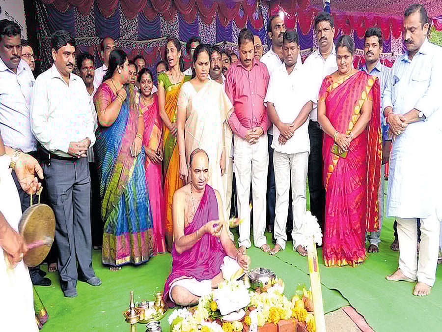 A priest offers prayer at the foundation stone laying ceremony for the construction of a new railway station at Innanje near Udupi on Sunday. MP Shobha Karandlaje looks on.