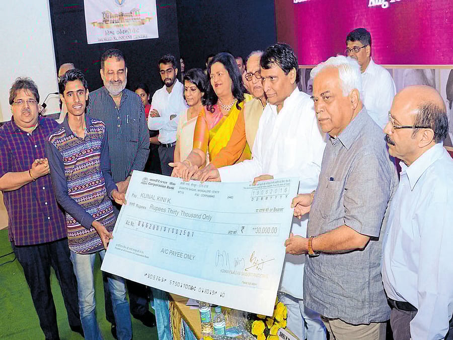 Union Railway Minister Suresh Prabhu hands over a chque of Vishwa Konkani Student Scholarship to a student at the scholarship presentation ceremony organised at T V Raman Pai Convention&#8200;Centre in Mangaluru on Friday. Minister for Large and Medium Scale Industries R V Deshpande, Ryan International Group of Institutions Managing Director Grace Pinto, VKSSF Secretary Pradeep G Pai and Vishwa Konkani Kendra Chairman Basti Vaman Shenoy look on.