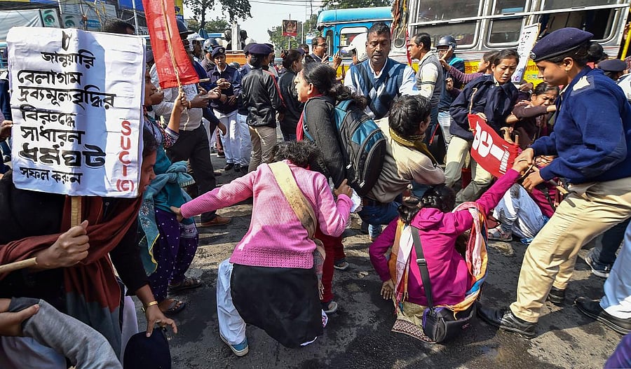 Police detain SUCI activists who were staging a road blockade in support of the trade unions' Bharat Bandh, in Kolkata. (PTI photo)