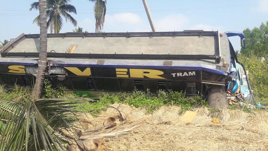 Bus carrying farmers that toppled near Bharathinagar, in Mandya, on Thursday. (DH Photo)