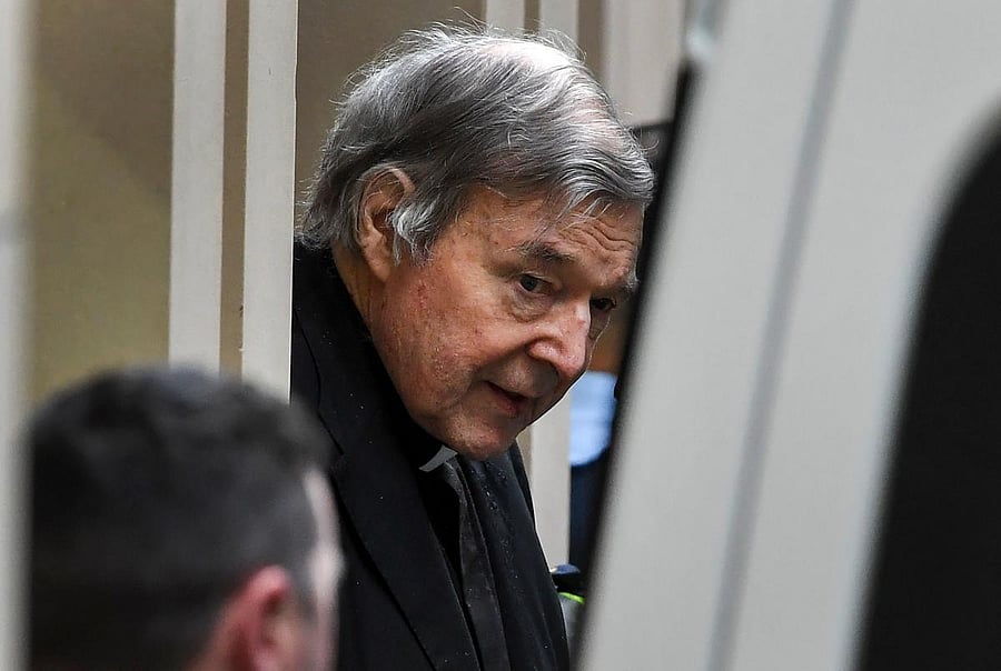 Australian Cardinal George Pell (C) is escorted in handcuffs from the Supreme Court of Victoria in Melbourne on August 21, 2019. (AFP Photo)