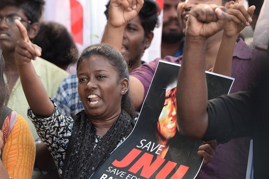 Members of Democratic Youth Federation of India (DYFI) along with Student Federation of Indian (SFI) hold placards and shout slogans during a protest against an attack on the students and teachers at the Jawaharlal Nehru University (JNU) campus in New Del