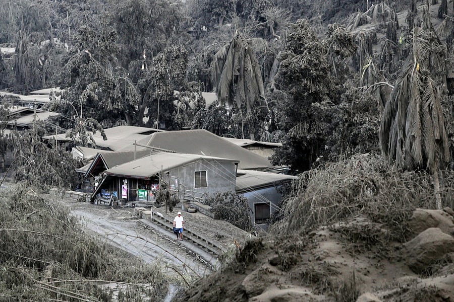 A man walks on a road covered with ashes from the erupting Taal Volcano in Talisay, Batangas, Philippines, January 13, 2020. (Reuters Photo)