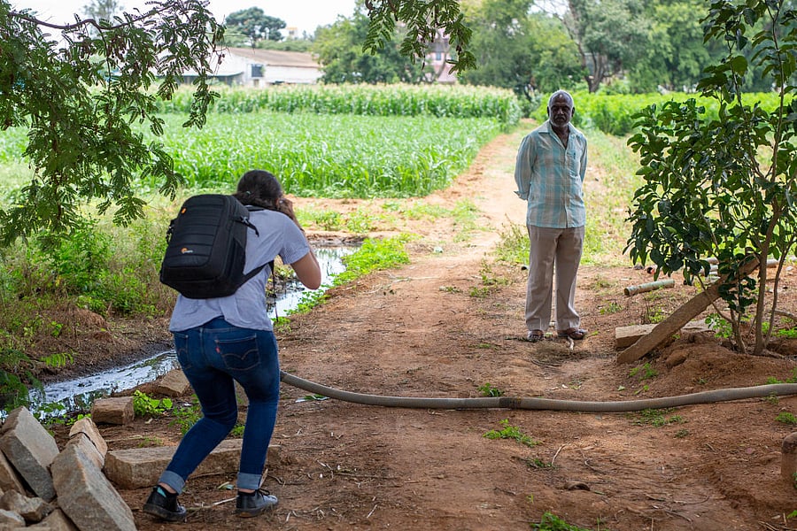 Isabella Porras, an undergraduate student from Griffith University, Brisbane in Australia, photographs a silkworm cultivator in Vijayapura in September 2019. The farmer said he uses wastewater to sustain his mulberry plants, which are fed on by silkworms,