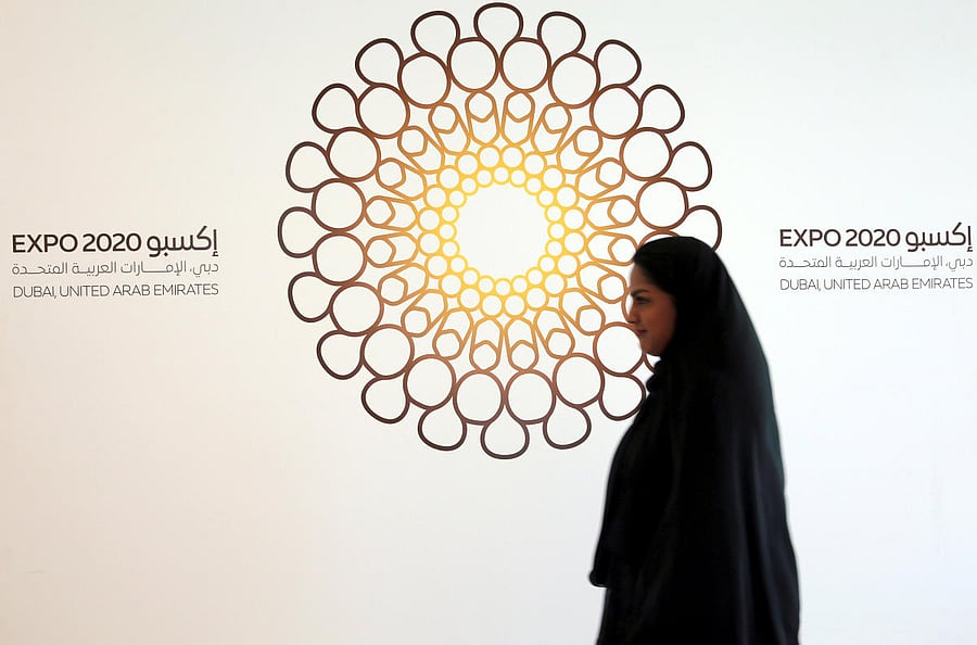 A woman walks past the logo of the Expo 2020 in Dubai, United Arab Emirates (Reuters Photo)