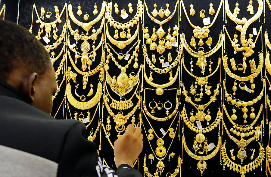 A man arranges gold jewels on a display inside a jewellery shop at Wuse market in Abuja, Nigeria June 26, 2019. (Reuters Photo)