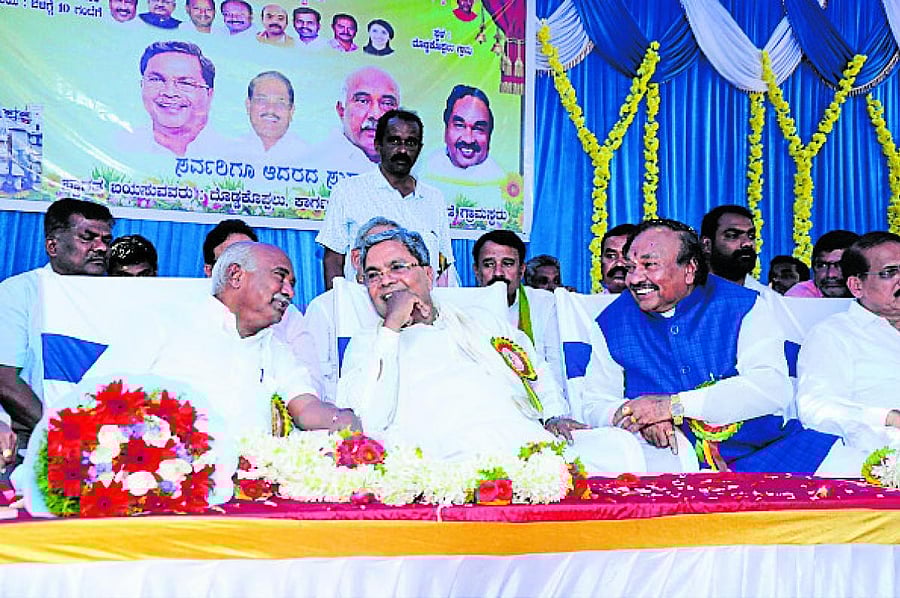 Leader of the Opposition in the Assembly Siddaramaiah, BJP leader A H Vishwanath and Minister K S Eshwarappa at a programme in Doddakoppalu village, K R Nagar taluk of Mysuru district on Sunday. (DH Photo)