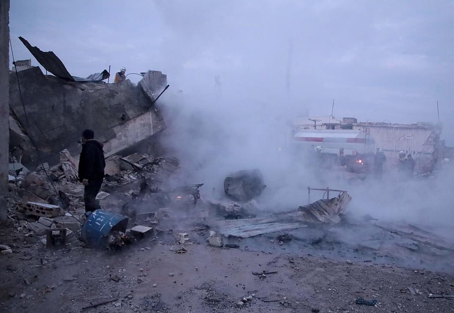 Members of the Syrian Civil Defence, also known as the White Helmets, fight a fire following a reported airstrike on the village of Kafr Nuran. (AFP Photo)