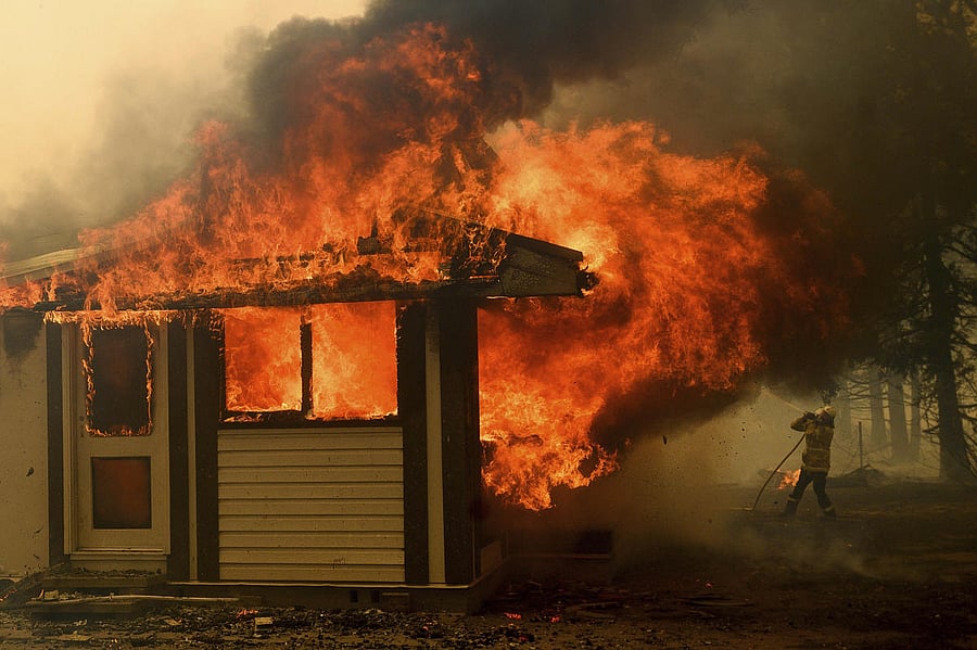 A firefighter battles the Morton Fire as it consumes a home near Bundanoon, New South Wales. AP/PTI