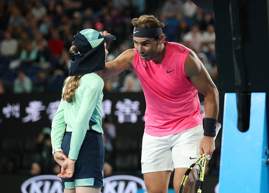Rafael Nadal checks on the ball girl after she was struck by the ball during the Spaniard’s match against Federico Delbonis. REUTERS