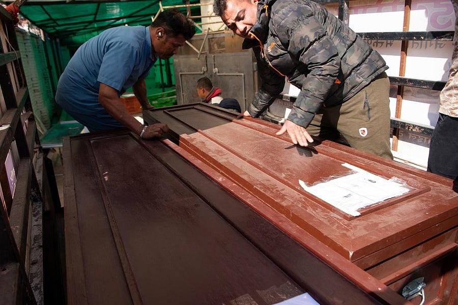 People carry coffins with the bodies of Indian tourist, who have died after they were found unconscious in their room at a hill resort in Nepal, at Teaching Hospital in Kathmandu on January 23, 2020. Credit: AFP File Photo
