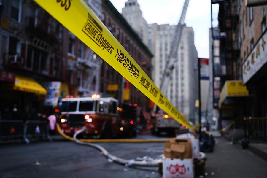 Firefighters continue to work in Chinatown the morning after a fire severely damaged a historic building that has been home to a senior center and other nonprofits for decades. (AFP Photo)