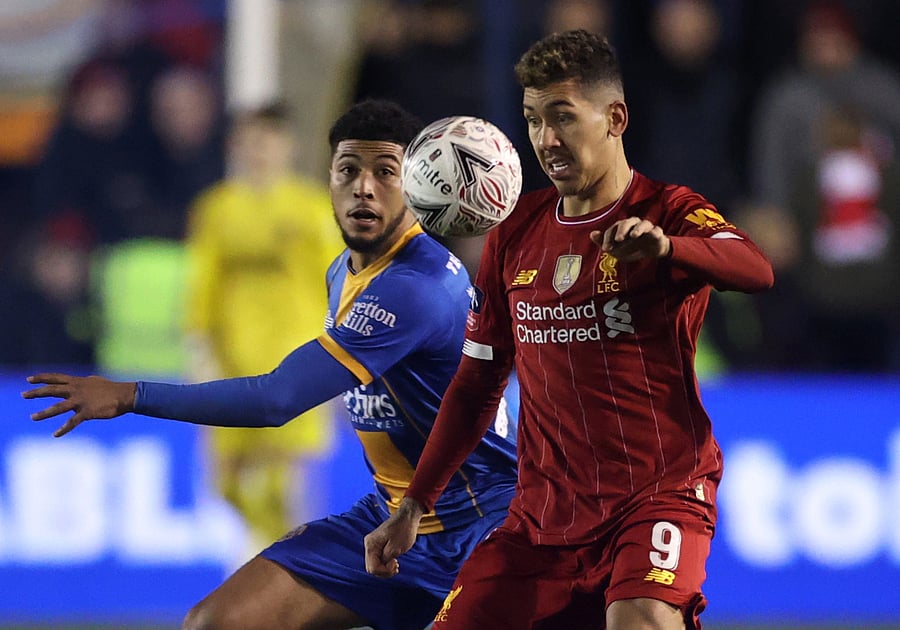 Liverpool's Roberto Firmino in action with Shrewsbury Town's Joshua Laurent. (Reuters Photo)