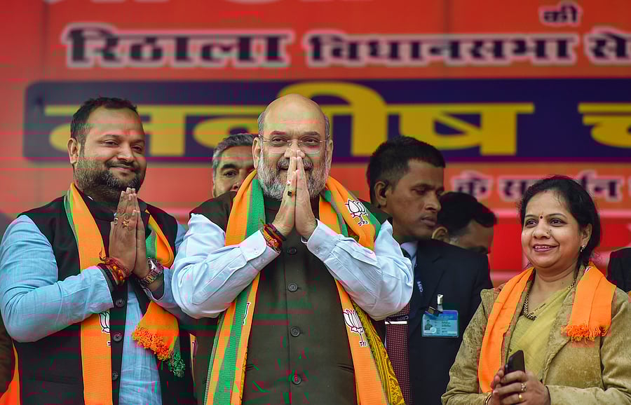 Union Home Minister and BJP leader Amit Shah (C) with party candidate Manish Choudhary (L) during an election campaign ahead of the forthcoming Delhi Assembly elections, at Rithala constituency in New Delhi, Monday, Jan. 27, 2020. (Credit: PTI Photo)