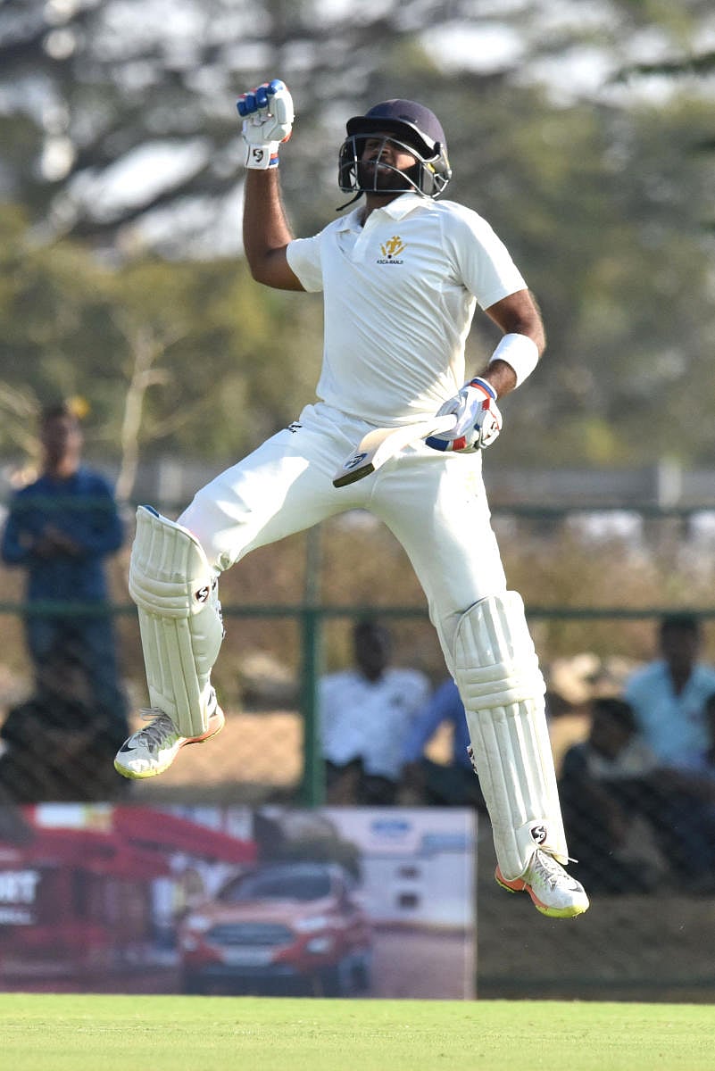 Karnataka opener R Samarth celebrates after bringing up his century against Madhya Pradesh on the opening day of their Ranji Trophy match at KSCA stadium in Shivamogga on Tuesday. DH Photo/ S K Dinesh