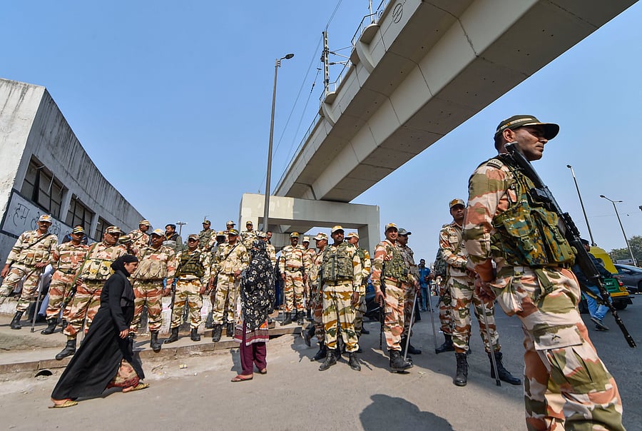 Security personnel stand guard at a polling station. (PTI Photo)