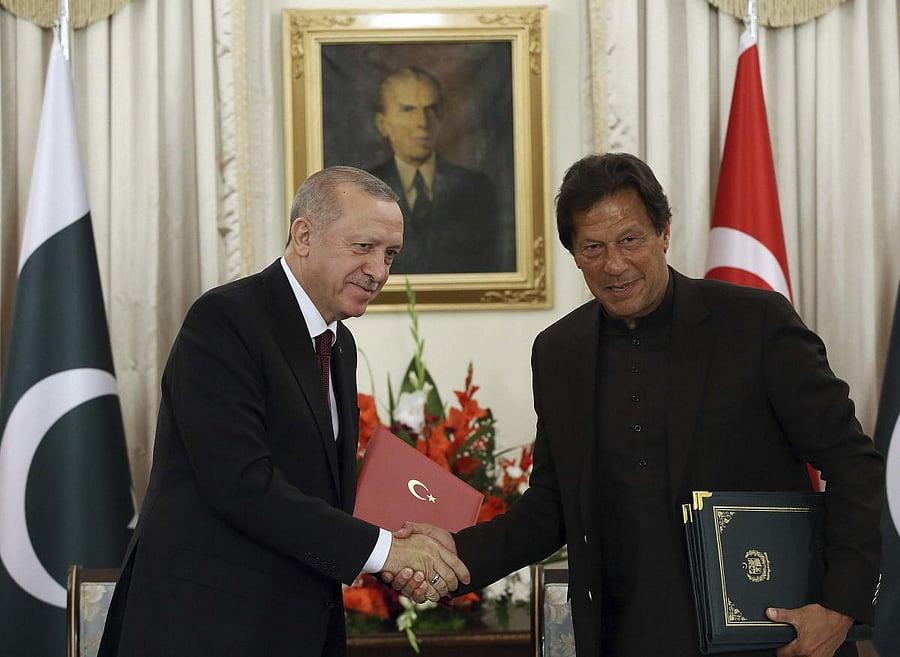 Turkey's President Recep Tayyip Erdogan, left, and Pakistan Prime Minister Imran Khan shake hands after signing of several agreements, in Islamabad, Pakistan. AP/PTI