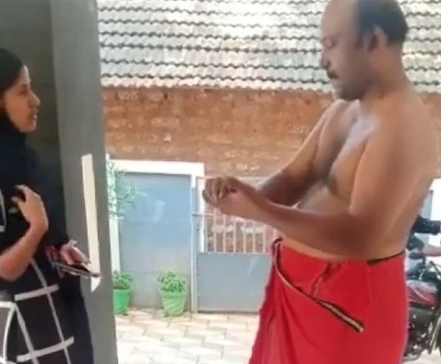 Video-grab of man tearing currency notes.