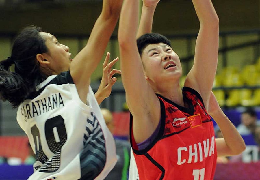 competitive: China's Zhou Ma (right) and Parinya Sarathana of Thailand clash during their tie at the Sree Kanteerava Stadium on Monday. DH photo/ Srikanta Sharma R
