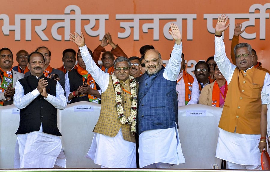 Union Minister and senior BJP leader Amit Shah welcomes Jharkhand Vikas Morcha (JVM-Prajatantrik) chief Babulal Marandi as he merged his JVM-P party with the BJP, in Jagannathpur area of Ranchi, Monday, Feb. 17, 2020. (PTI Photo)