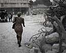 A woman walks through a destroyed area in Port-au-Prince on Tuesday. A powerful earthquake hit Haiti on Jan. 12. AP