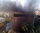 Smoke billows from Carlton Towers in Bangalore on Tuesday. PTI