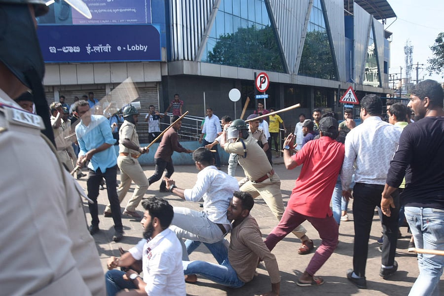 Police cane protesters near DC’s office in Mangaluru.