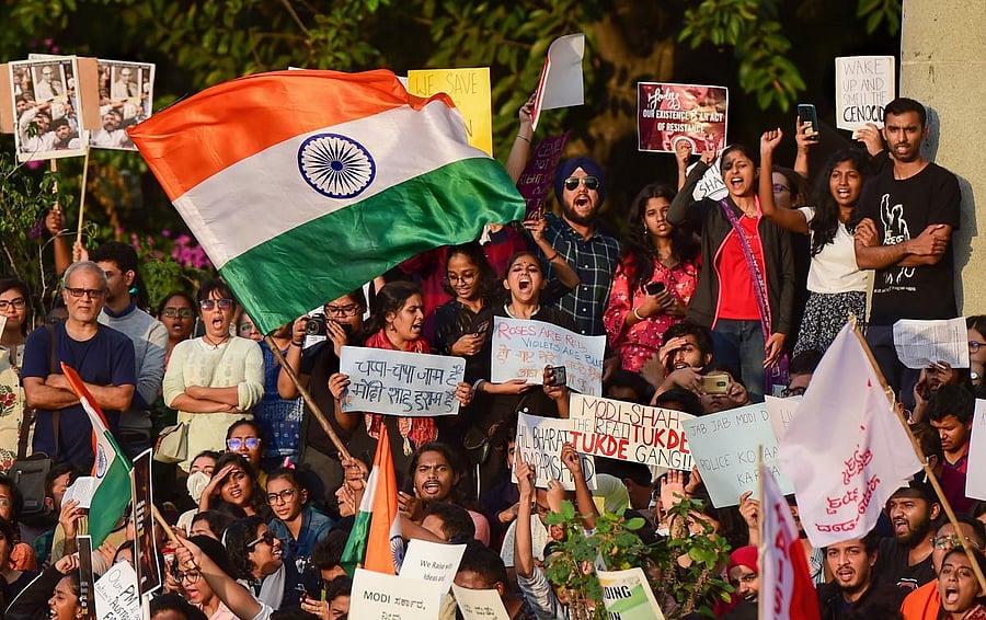 Protesters display placard and raise slogans during a rally against the Citizenship Amendment Act (CAA). (Credit: PTI file photo) 