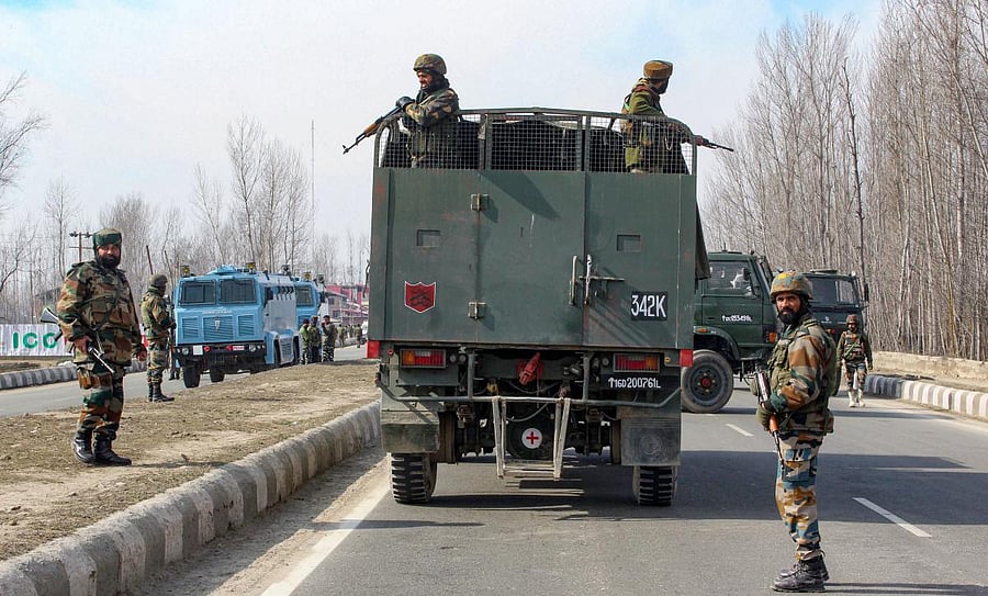 Army jawans take positions during an encounter with the militants at Lawaypora on the Srinagar-Baramulla National Highway, near Srinagar, Wednesday, Feb. 5, 2020. Two militants and a CRPF jawan were killed in the encounter and one militant was arrested alive in injured condition. (PTI Photo)
