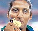India's discus thrower Krishna Poonia poses with her gold medal after winning the women's discus throw event of the Commonwealth Games . PTI File Photo