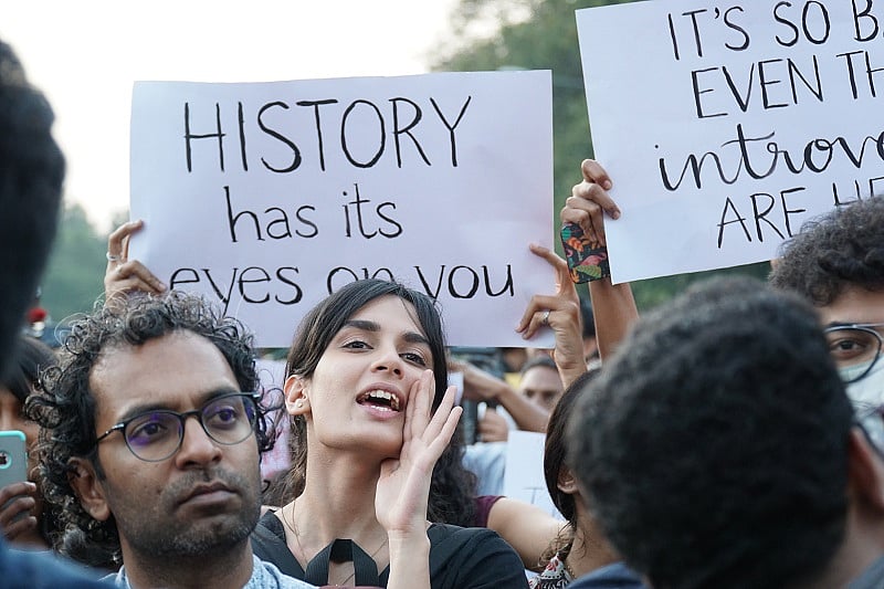 A young women shouts a slogan during a protest against CAA in front of Town hall on Sunday. (DH Photo)