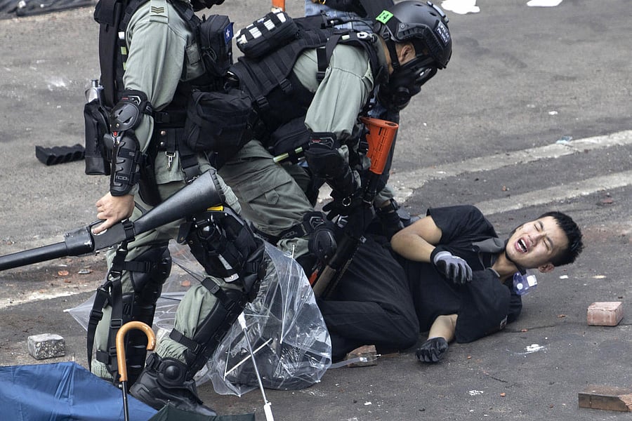 Riot police pin down a protester trying to flee from the Hong Kong Polytechnic University in Hong Kong. (AP/PTI Photo)