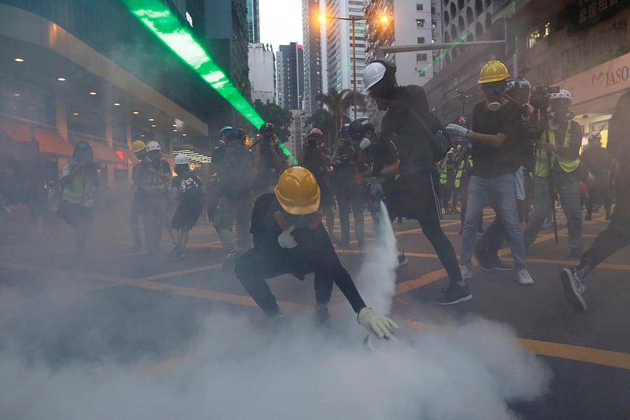 Protesters hurled bricks at officers and ignored warnings to leave the Sham Shui Po area before tear gas was deployed, police said, calling the march an "unauthorized assembly." (Reuters)