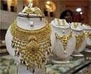 A saleswoman stands behind the showcased gold necklaces at a jewellery showroom in Agartala- Reuters photo