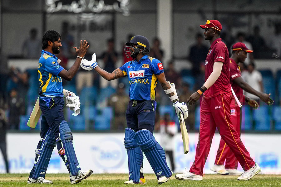 Sri Lanka's Wanindu Hasaranga (C) and Nuwan Pradeep (L) celebrate after Sri Lanka won by 1 wicket during the first one day international (ODI) cricket match between Sri Lanka and West Indies at the Sinhalese Sports Club (SSC) International Cricket Stadium in Colombo. (AFP Photo)