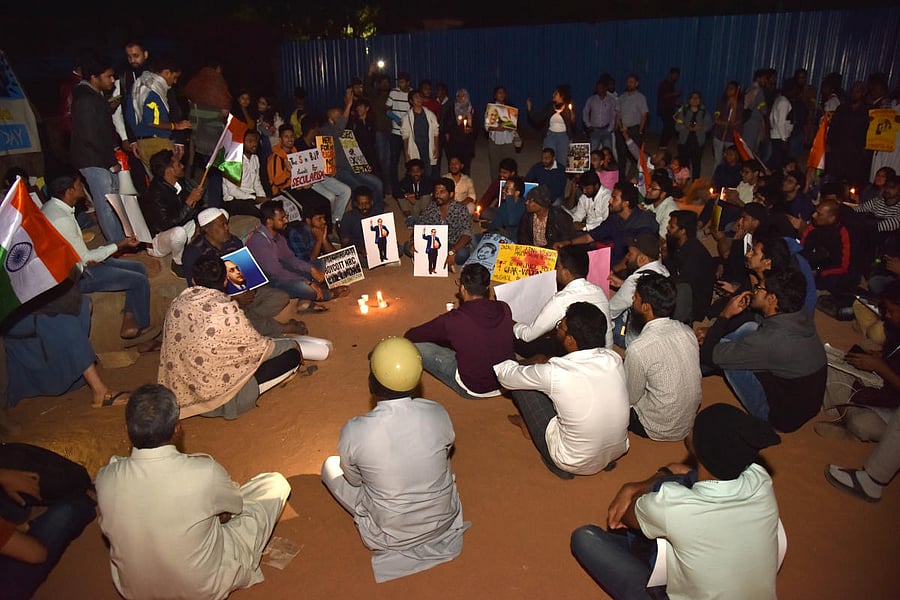 Anti-CAA protesters during a candlelight vigil at Freedom Park in Bengaluru on Friday. DH PHOTO/Janardhan B K
