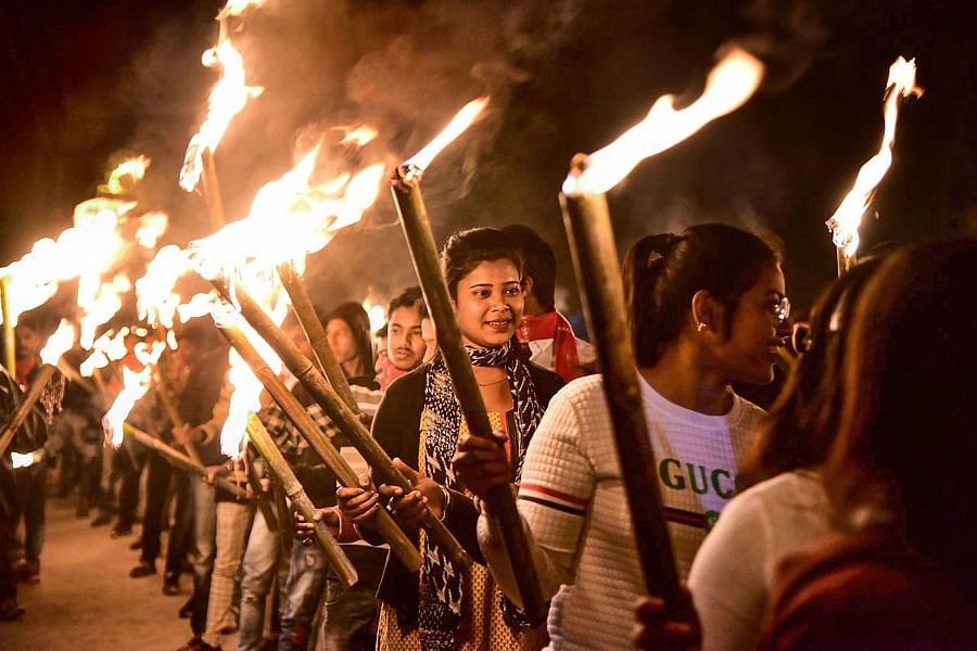 Activist of All Assam Students Union (AASU) take part in a torch rally during a protest against a new citizenship law in Nagaon district of Assam. (PTI Photo)