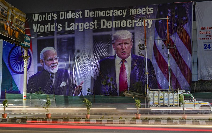 A view of a hoarding with images of Prime Minister Narendra Modi and US President Donald Trump, ahead of Trump’s maiden visit to India, in Agra, Saturday, Feb. 22, 2020. Credit: PTI Photo