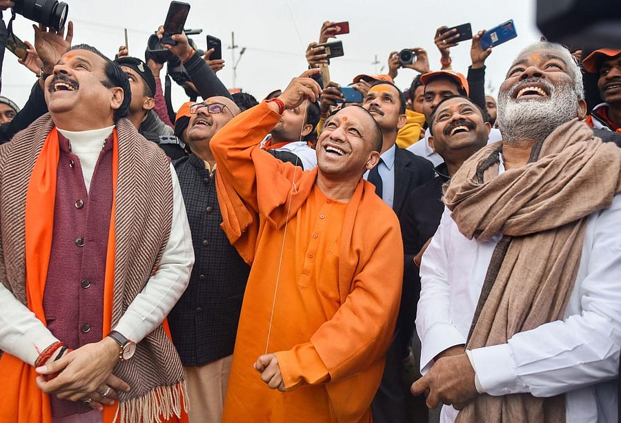 UP Chief Minister Yogi Adityanath flies a kite on the auspicious day of 'Basant Panchami' during Ganga Yatra, in Prayagraj. PTI