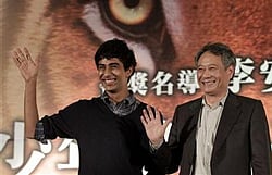 Taiwan-born director Ang Lee (R) and cast member Suraj Sharma of India wave during a news conference to promote their latest film ''The Life of Pi'' in Taipei November 7, 2012.  Credit: Reuters