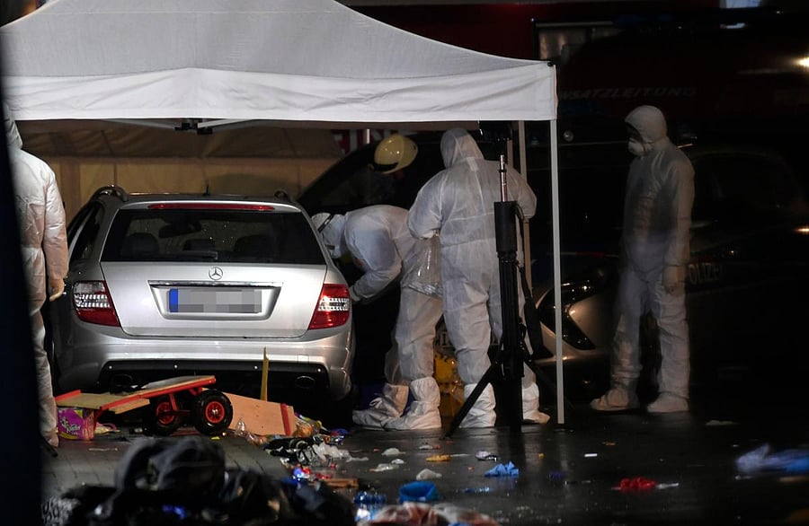Police officers investigate the car of the man who drove into a carnival procession on February 24, 2020 in Volkmarsen near Kassel, central Germany. (AFP Photo)