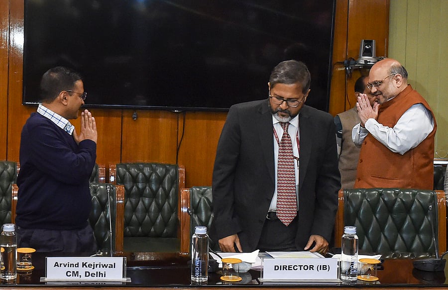 Delhi Chief Minister Arvind Kejriwal (L) greets Union Home Minister Amit Shah as he arrives for a meeting to discuss the prevailing situation in the national capital after violence in northeast Delhi over the amended citizenship law. (Credit: PTI Photo)