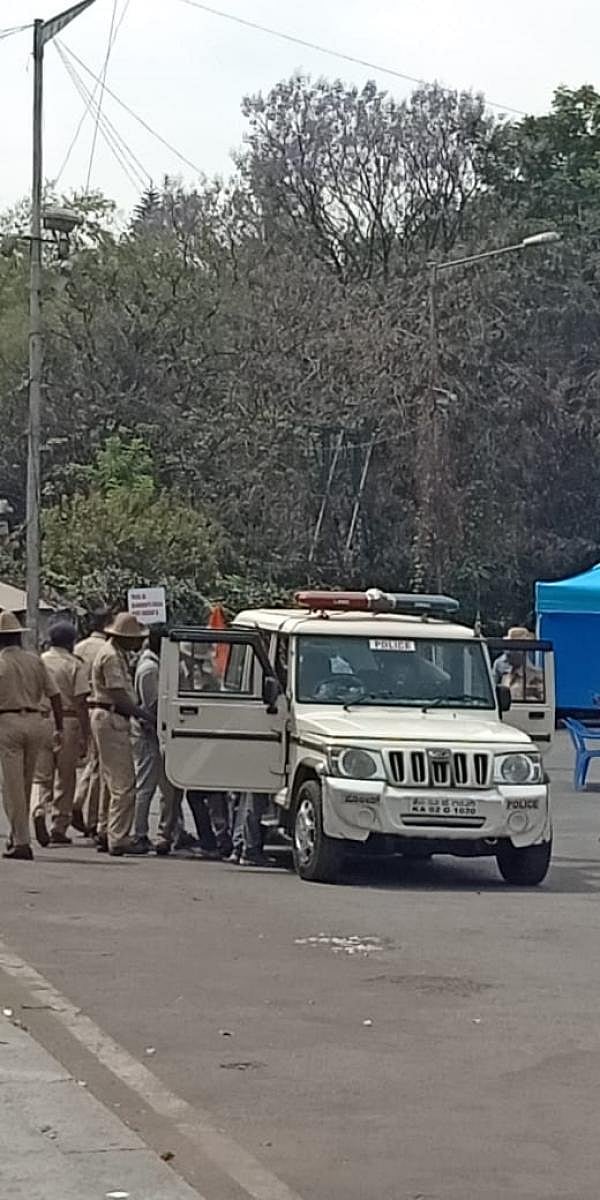 Cops force the students into a car on Monday.