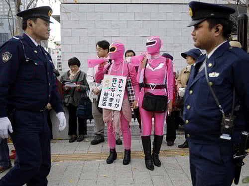 Protesters shout slogans near police officers during a rally against the government's planned state secrets act in front of the parliament building in Tokyo. Reuters